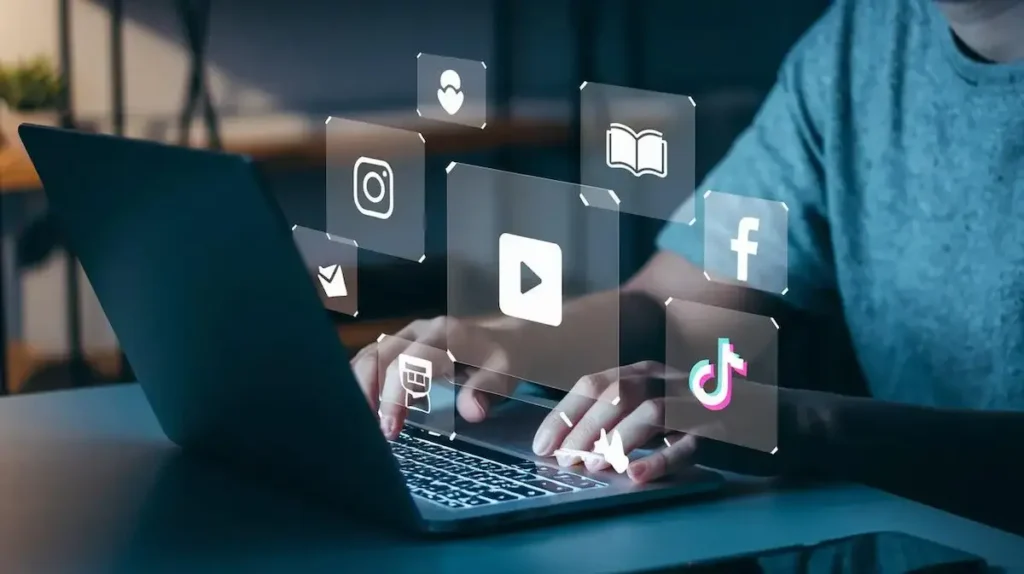 Person using laptop with social media icons